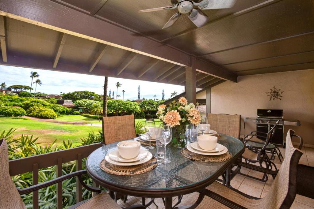a dining room with a table and chairs on a balcony at K B M Resorts Kaanapali KPL-41 3 bdm wRental Car in Kaanapali