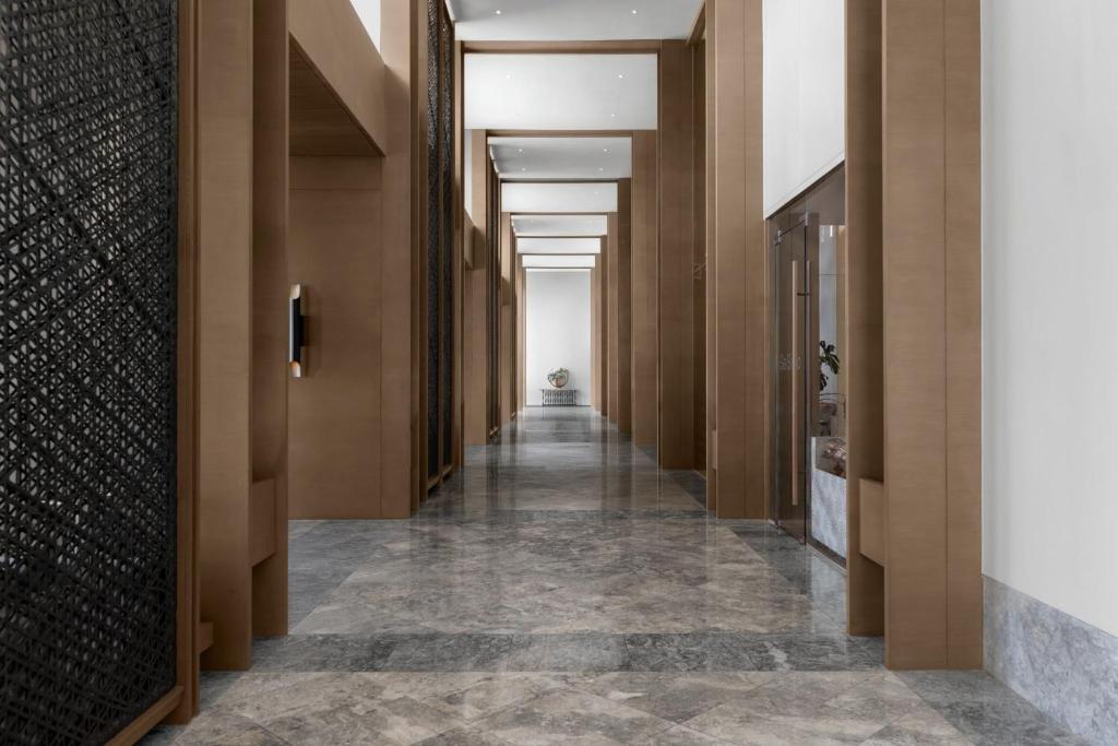 a hallway in a building with wooden walls and ceilings at Sheraton Cebu Mactan Resort in Mactan