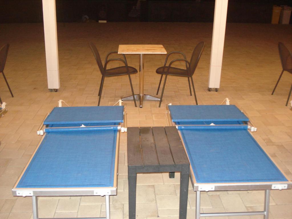 two ping pong tables and chairs in a room at Villa Lara in Polignano a Mare