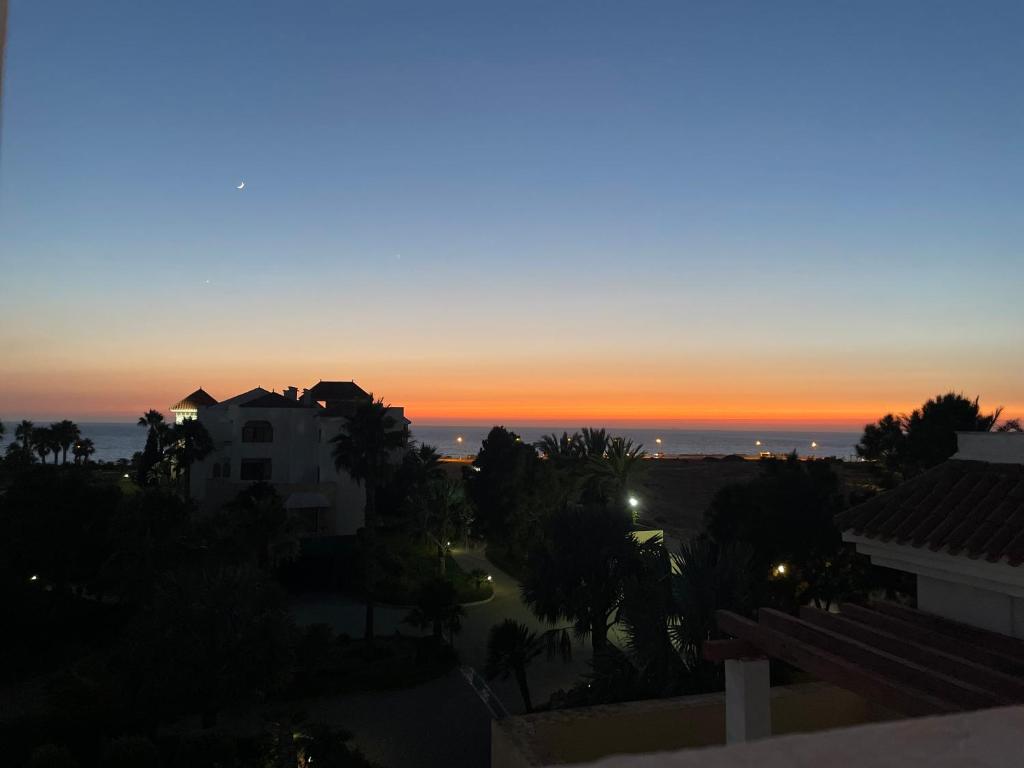 a sunset from the roof of a building at Atlantic Magna in Tangier