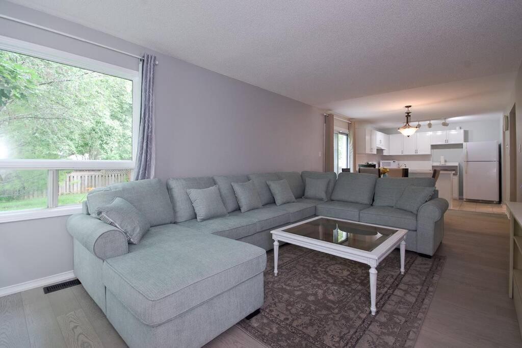 a living room with a couch and a table at Lake Simicoe town cottage near Innisfil Beach Park in Innisfil