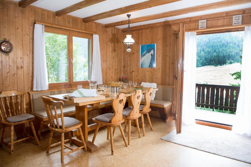 a dining room with a wooden table and chairs at 5 room house Joch Churwalden- Lenzerheide in Churwalden