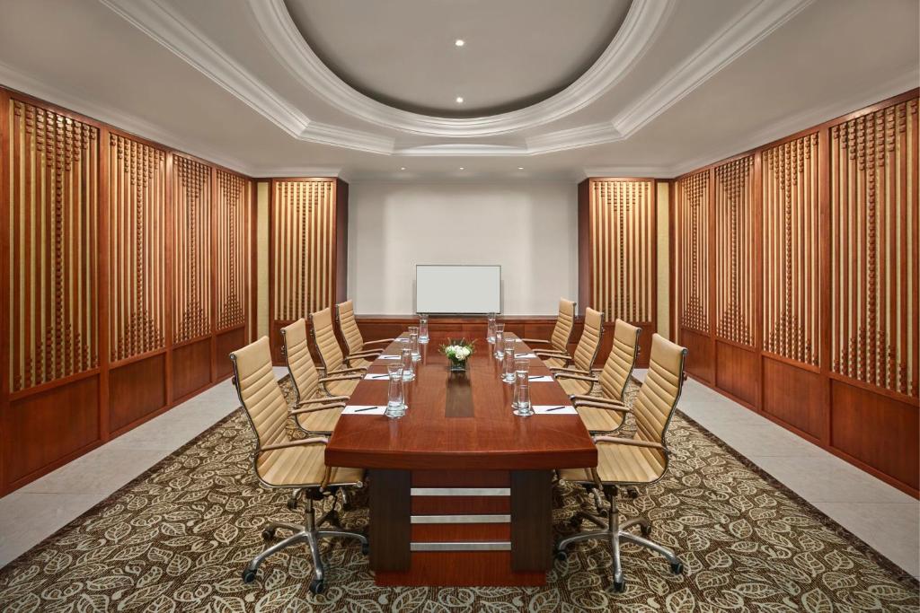A private boardroom with a polished wood table and executive-style seating.