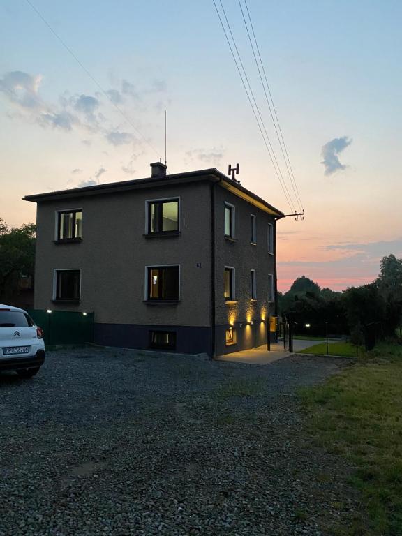 a house with a car parked in front of it at Pokoje Green House in Ustroń