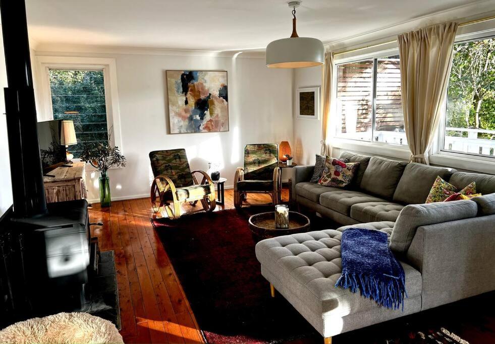 a living room with a couch and a table at The Treehouse at Copa in Copacabana