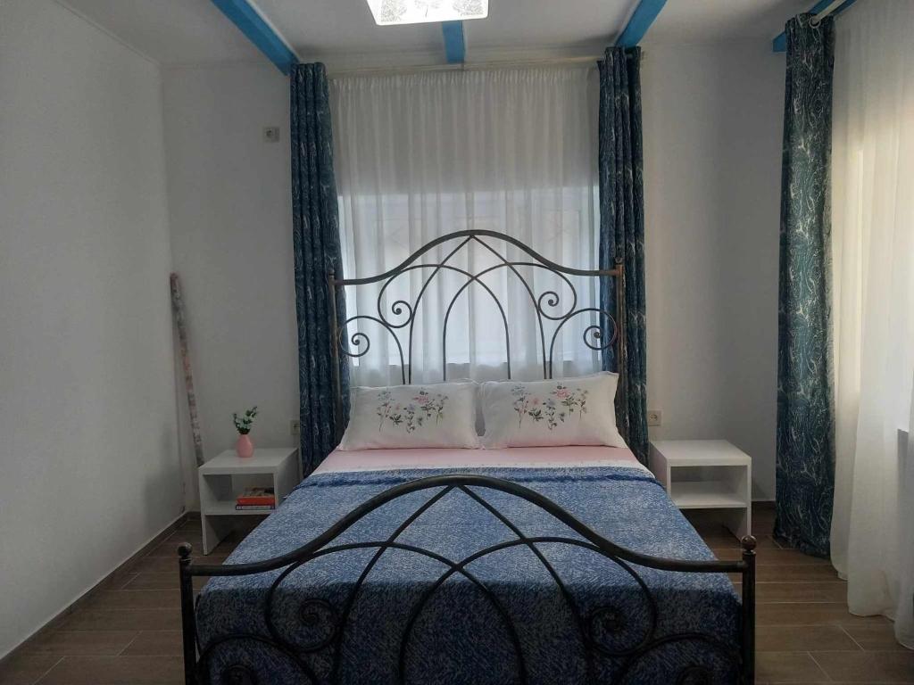 a bedroom with a bed with a black headboard at Guest house of gnomes in Akhmety
