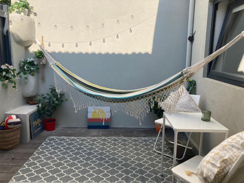 a hammock hanging from the side of a building at Oporto city center charming house in Porto