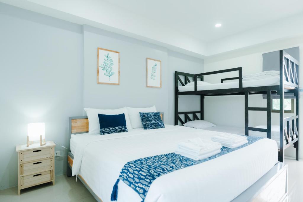 a bedroom with a bed and a bunk bed at Annahouse in Chiang Rai