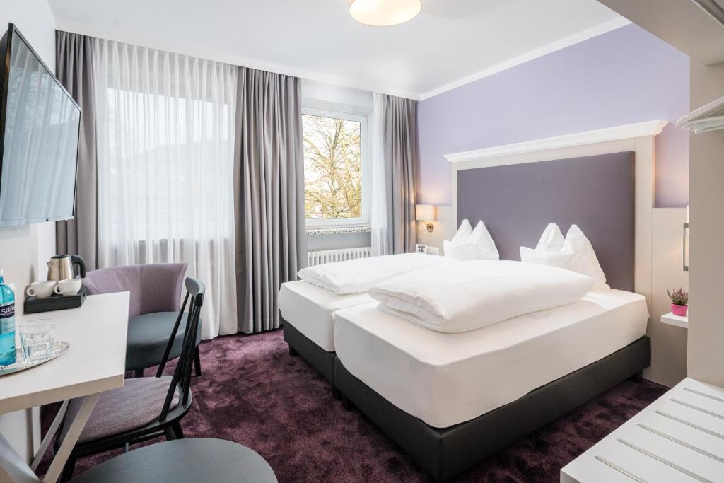 Postel nebo postele na pokoji v ubytování Flair Hotel Rieckmann