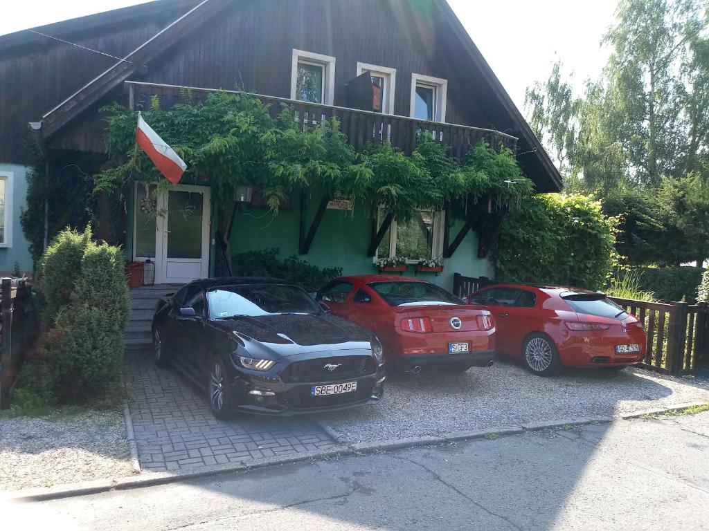 three cars parked in front of a house at Villa- Jaś in Polanica-Zdrój