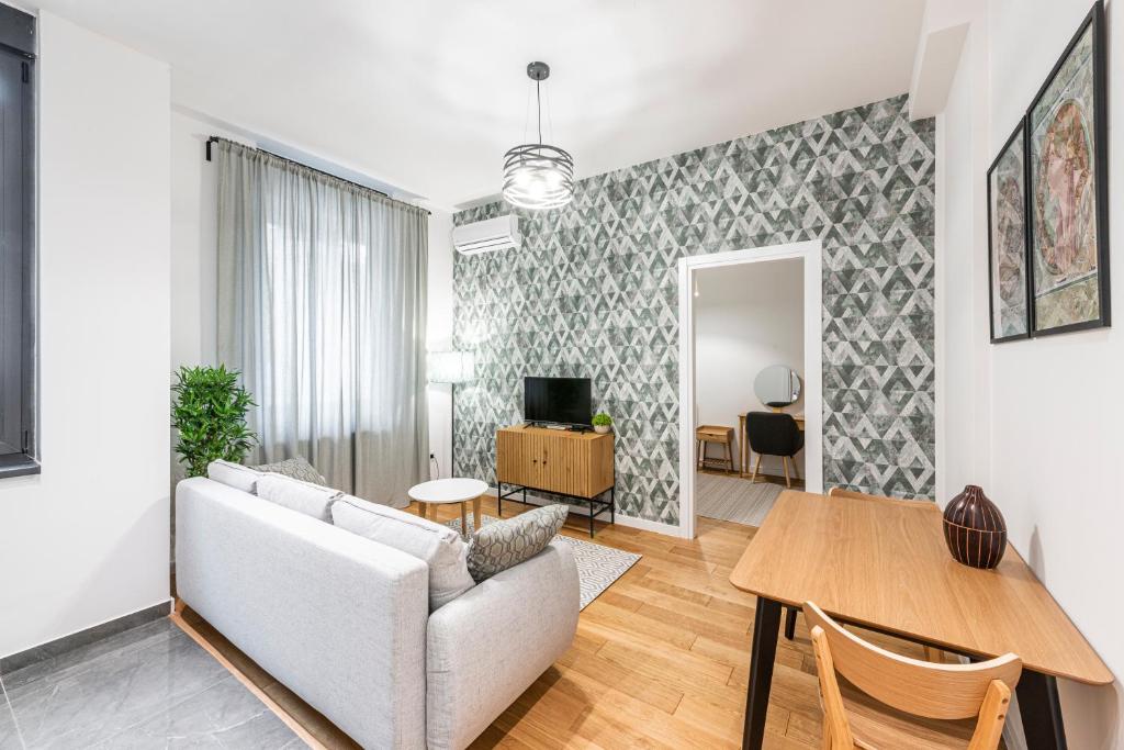 a living room with a couch and a table at VERTIGO One Bedroom apartment - Free private parking-Fast WI-FI in Novi Sad