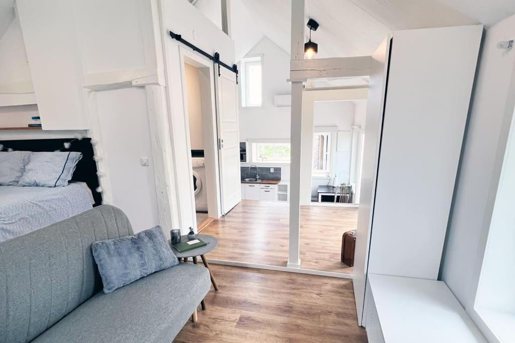 a living room with a couch and a bedroom at Pebble Cottage•Yard•Parking•Wifi in Stockholm