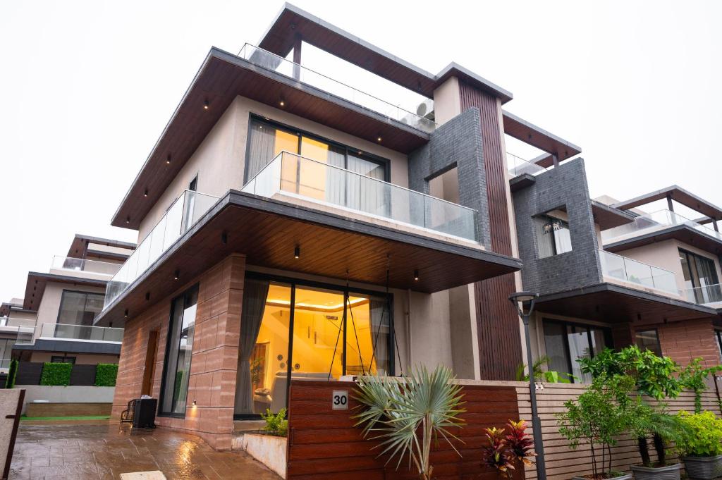 a house with a large window and a balcony at Villa Amara 30 by Stay ALYF, Lonavala in Lonavala