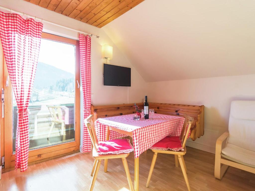 Comfortable Apartment in Thomatal near Ski Area في Thomatal: غرفة طعام مع طاولة وكراسي ونافذة