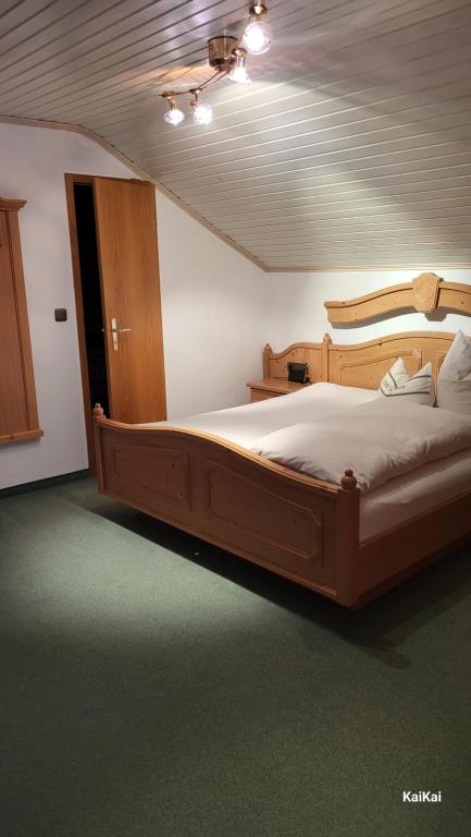 a bedroom with a large wooden bed in a room at Erd´s Hoimatle in Jungholz