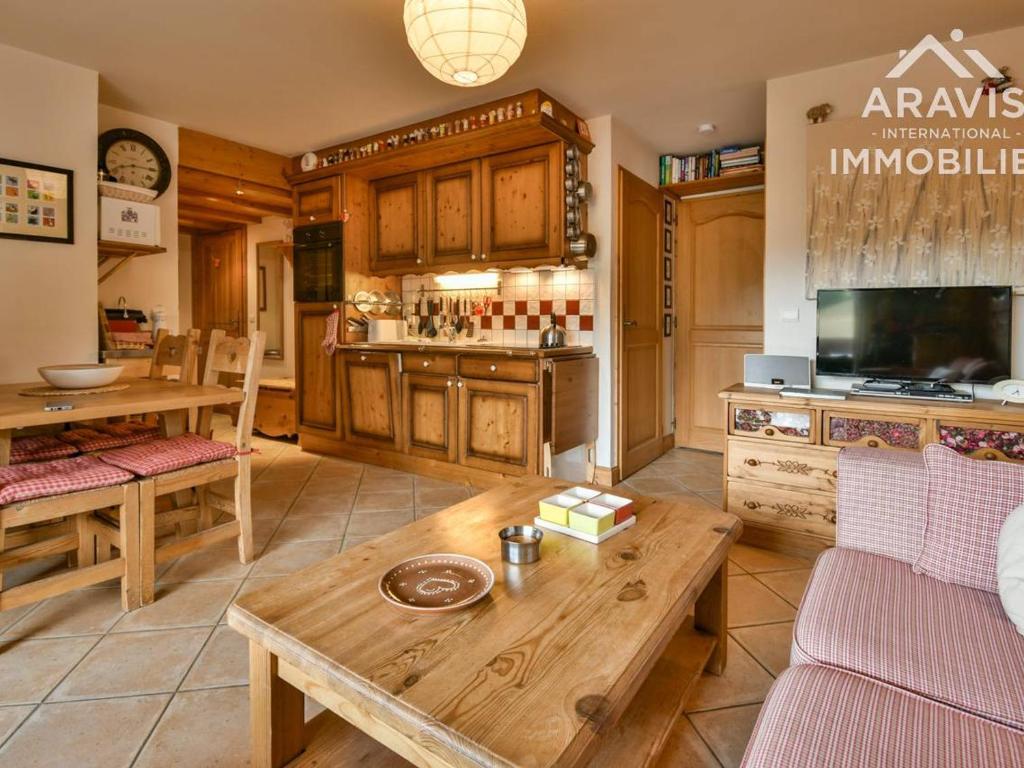 a living room with a table and a kitchen at Appartement Le Grand-Bornand, 3 pièces, 4 personnes - FR-1-391-5 in Le Grand-Bornand