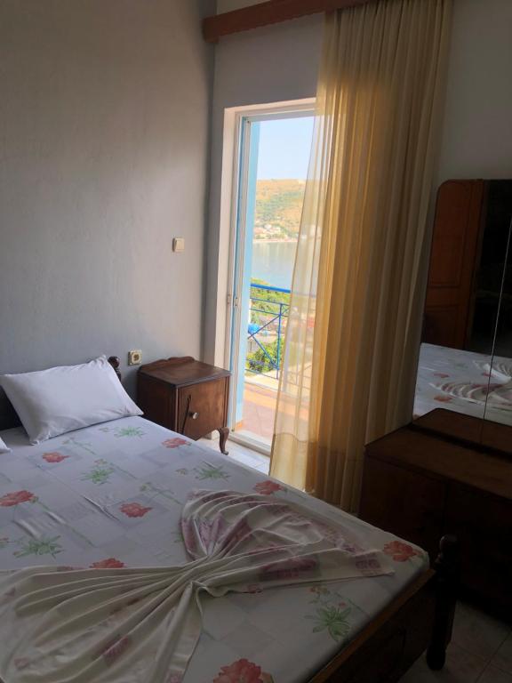a bedroom with a bed and a window with a view at Dina House in Himare