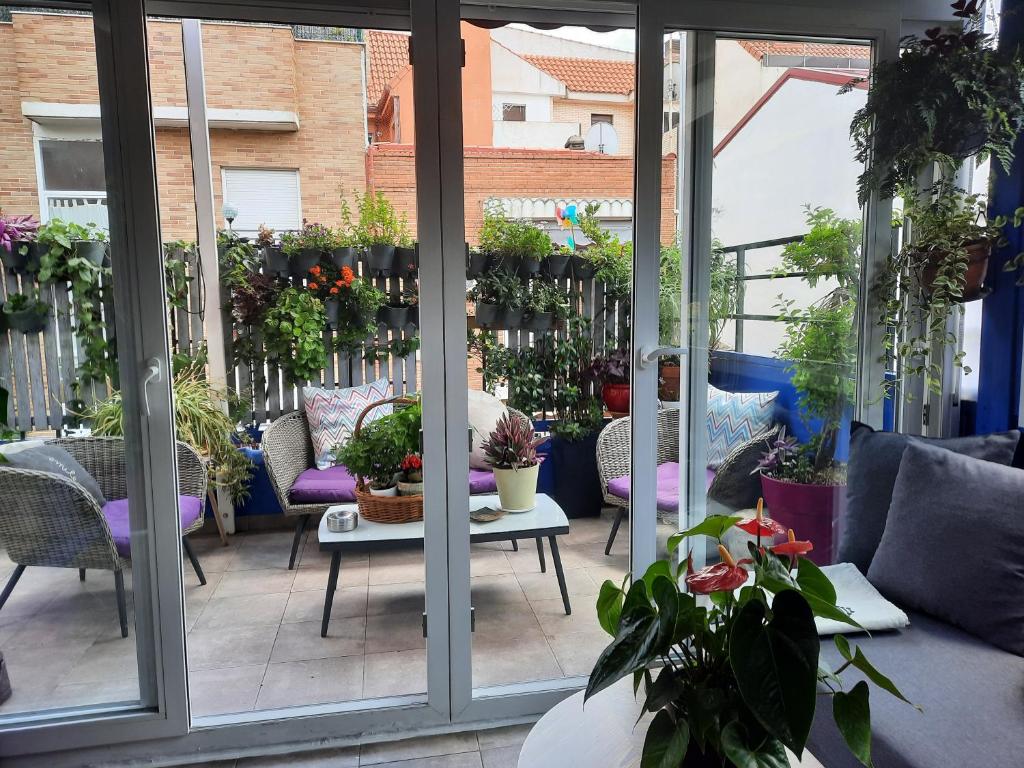 a patio with a bunch of potted plants at Loft con jardin in Madrid