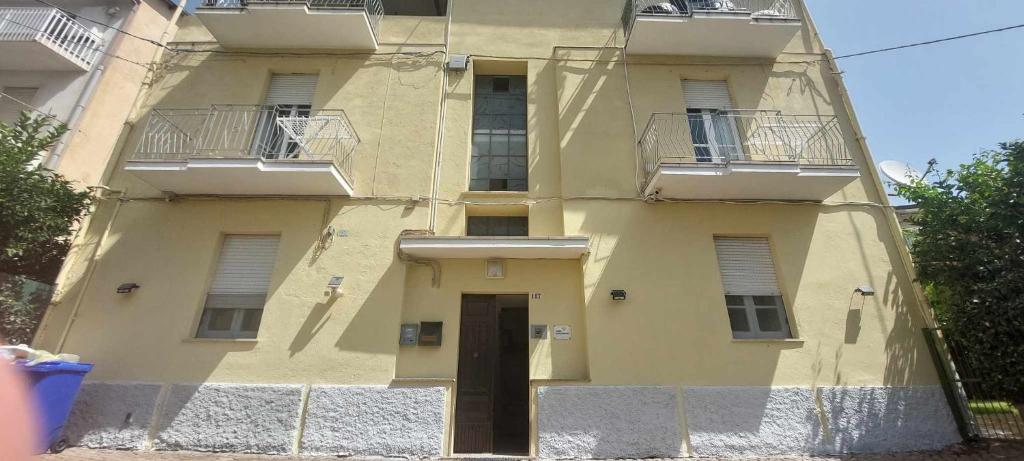 ein gelbes Gebäude mit einer Tür davor in der Unterkunft Barnet House Lamezia in Lamezia Terme