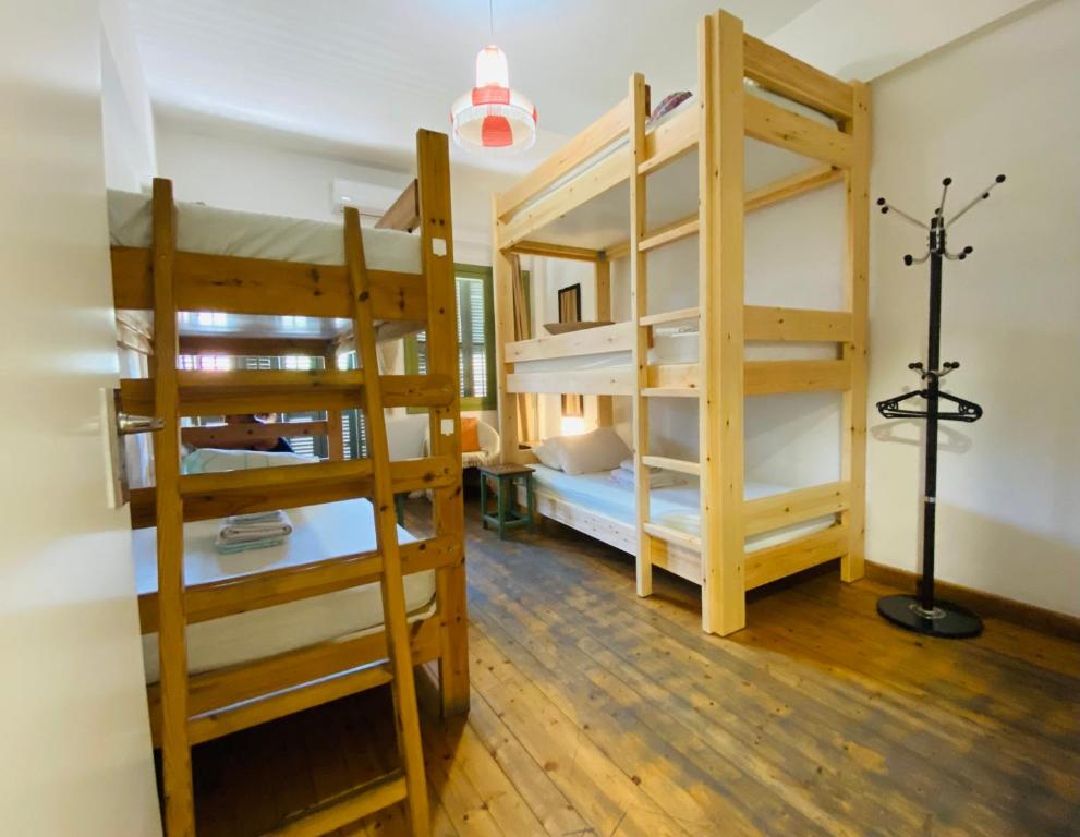 a room with three bunk beds and a room with a lamp at Lima Sol House in Limassol