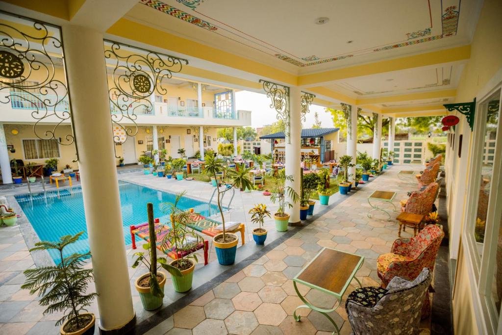 een binnenlobby met een zwembad en planten bij Dá Bungalow - A Vacation Abode in Agra