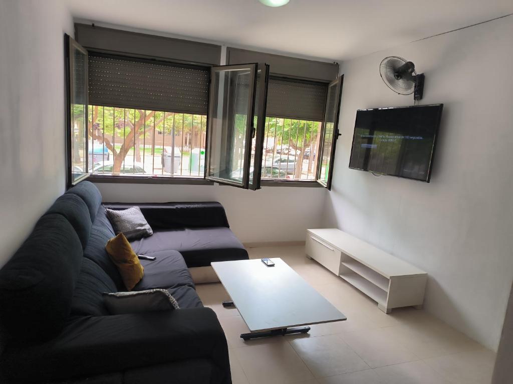 a living room with a couch and a table at turisblo apartamento 2 in Benicarló