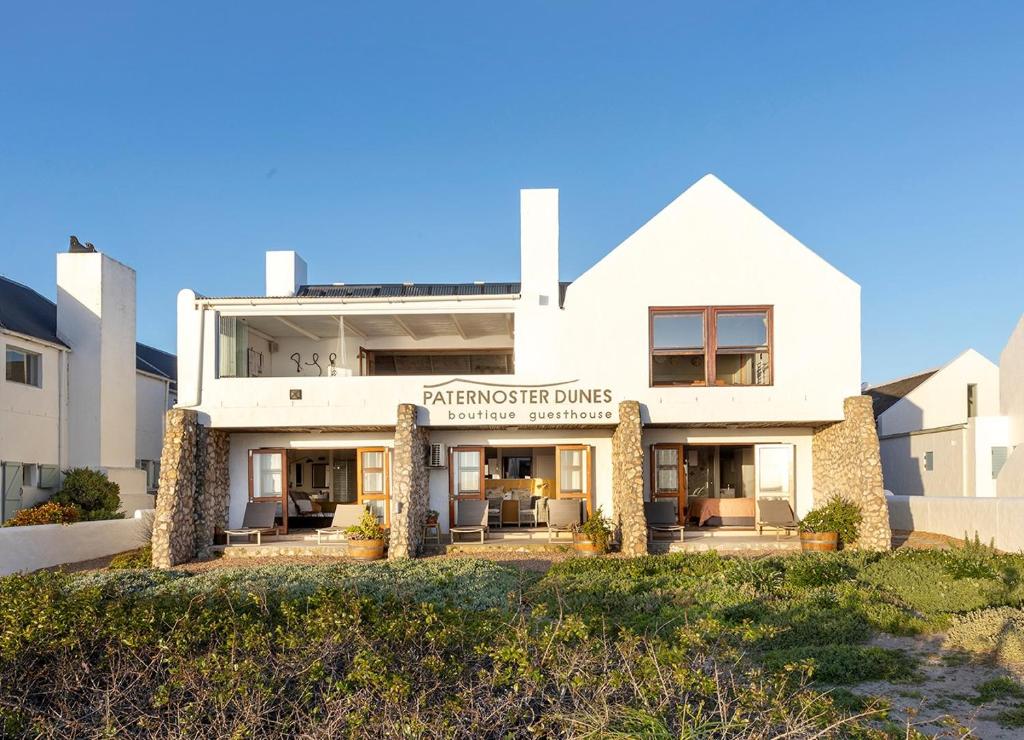 a white building with a sign that reads hamsteritage drugs at Paternoster Dunes Boutique Guesthouse in Paternoster