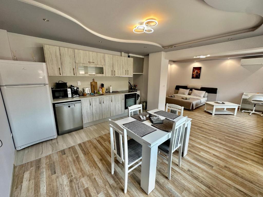 een keuken en een woonkamer met een tafel en een koelkast bij Central Vista Apartment by LMG in Sofia