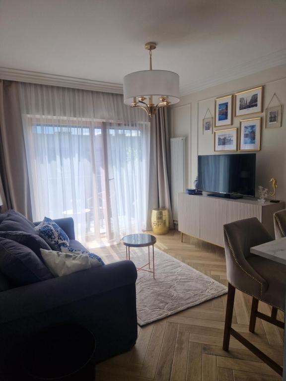 Televízia a/alebo spoločenská miestnosť v ubytovaní Serce miasta Gdansk apartament