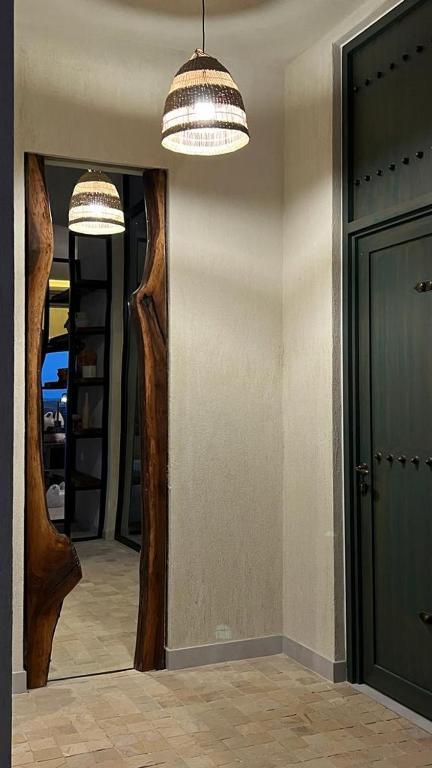 a hallway with two mirrors and a door in a room at The Gate in Sur