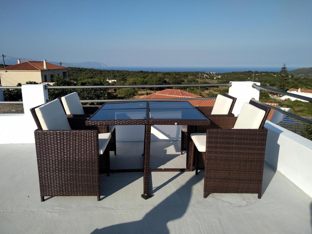 a table and chairs on a balcony with a view at Harmony at Trifilianika in Trifilliánika