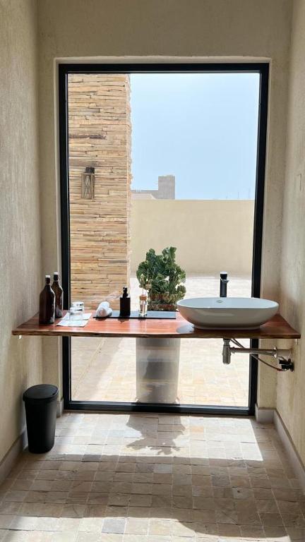 a bathroom with a sink and a large window at The Gate in Sur