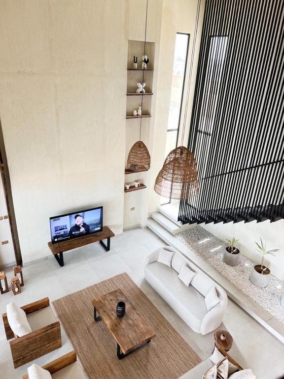 a living room with a couch and a tv at The Gate in Sur