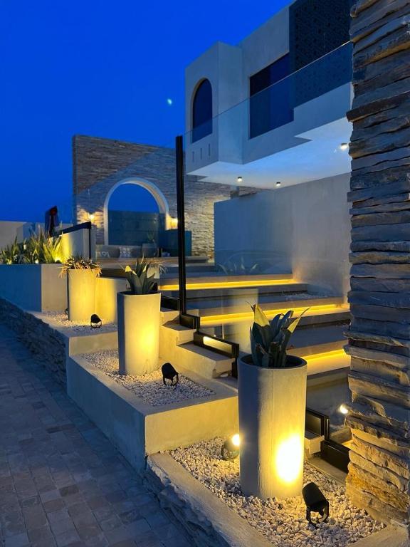a group of potted plants and lights in a building at The Gate in Sur