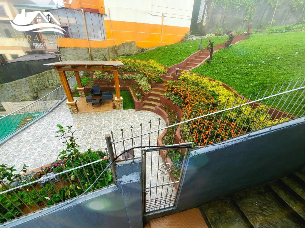 a set of stairs with a table and some plants at Mirador Old-Time House walking distance to Lourdes Grotto in Baguio