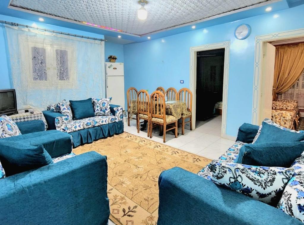 a living room with blue walls and blue couches at Family friendly 3 bedrooms apartment for rent in Hadayek El Maadi. in Cairo