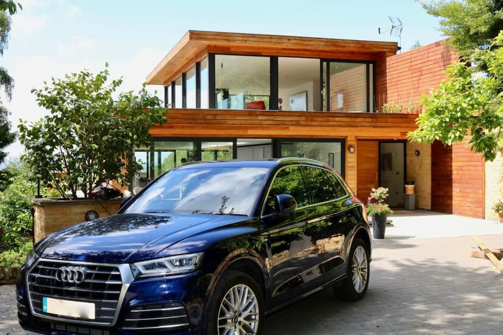 a car parked in front of a house at Fantastic Cotswolds hideaway Cleeve Hill in Southam