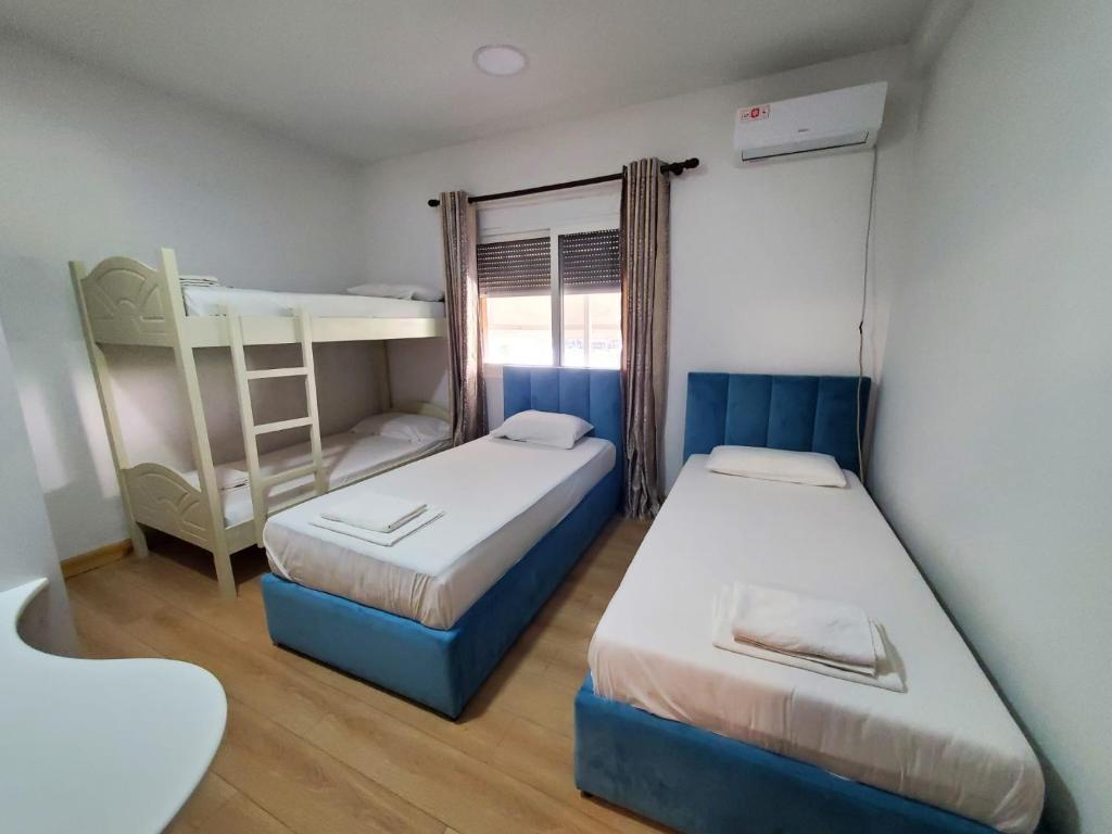 a bedroom with two beds and a bunk bed at Top view hostel in Durrës