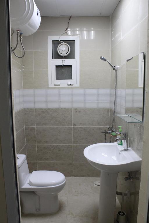 a bathroom with a toilet and a sink at Bedya Farm in Khor Fakkan