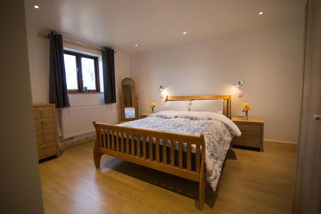 a bedroom with a large bed and a window at Owls Roost 2 en-suites, nr Port Isaac & Tintagel in Camelford