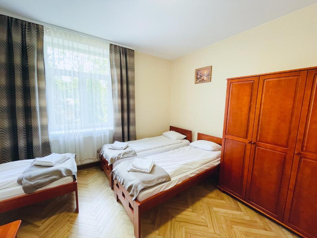 Posteľ alebo postele v izbe v ubytovaní Parkowa Rezydencja Hubal
