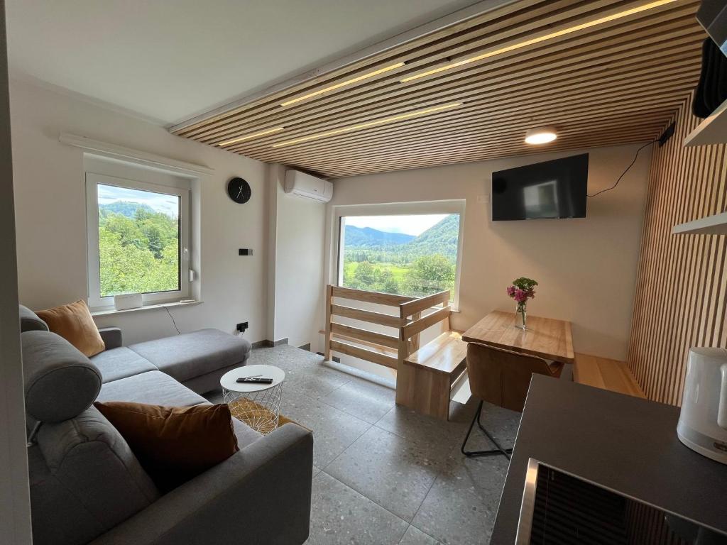 a living room with a couch and a tv at Panorama 13 in Tolmin