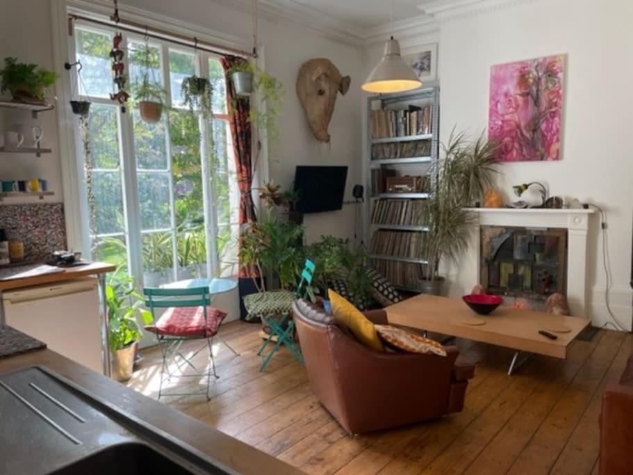 a living room with a couch and a table at Artistic spacious flat in central Brixton in London