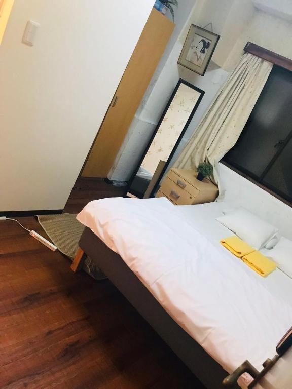Postel nebo postele na pokoji v ubytování Shinjuku Sky hostel