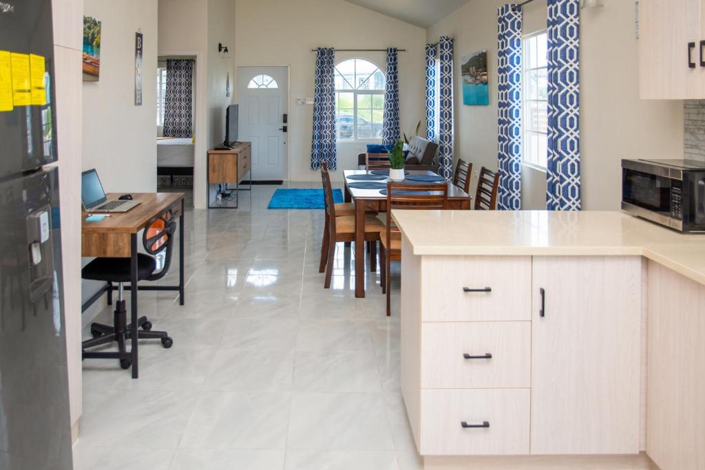 a kitchen and dining room with a table and chairs at OceanView Villa in Discovery Bay