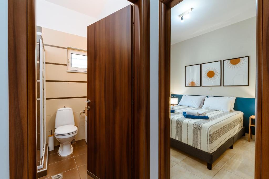 Postel nebo postele na pokoji v ubytování Harmony Apartments