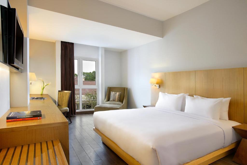 Postel nebo postele na pokoji v ubytování Hotel Santika Mataram