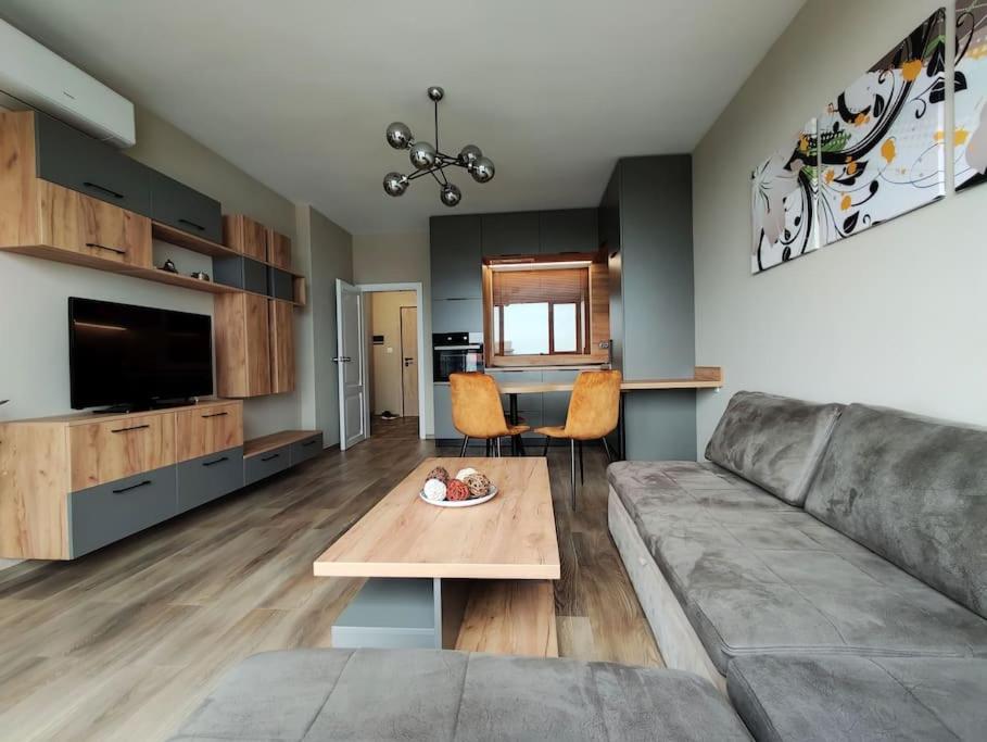 a living room with a couch and a table at Riverview apartment - Free Private Parking in Plovdiv