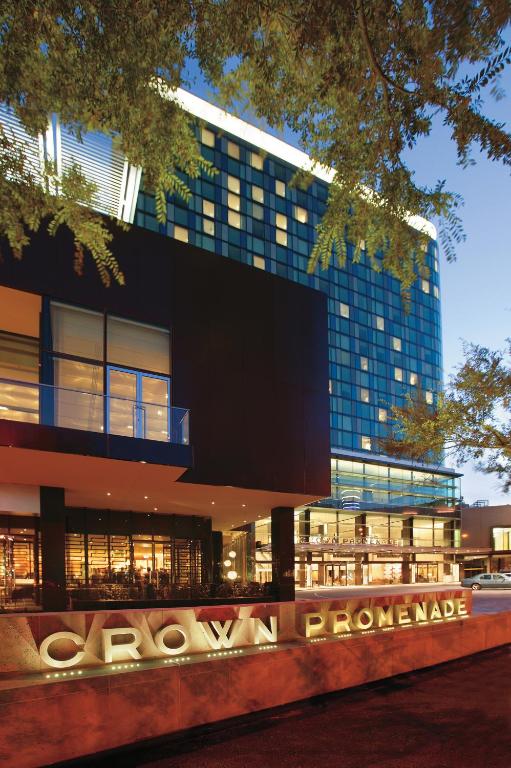 a large building with a sign in front of it at Crown Promenade Melbourne in Melbourne