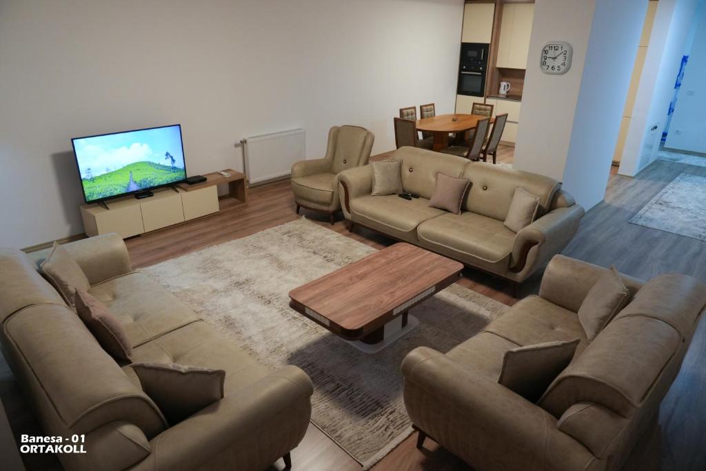 a living room with couches and a flat screen tv at APARTMENT Ortakoll prizren 2 bedroom in Prizren